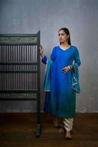 Festive Edit :Green Blue Asymmetric Dupion Silk Ombre Kurta With Woven Tussar Broad Pants And Chanderi Mokesh Work Dupatta.