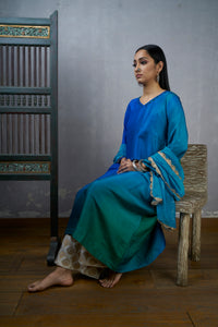 Festive Edit :Green Blue Asymmetric Dupion Silk Ombre Kurta With Woven Tussar Broad Pants And Chanderi Mokesh Work Dupatta.